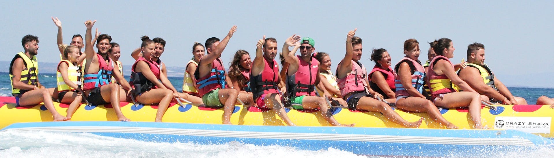 Group waving to the camera from the inflatable rented from St. Nicholas Beach Watersports.
