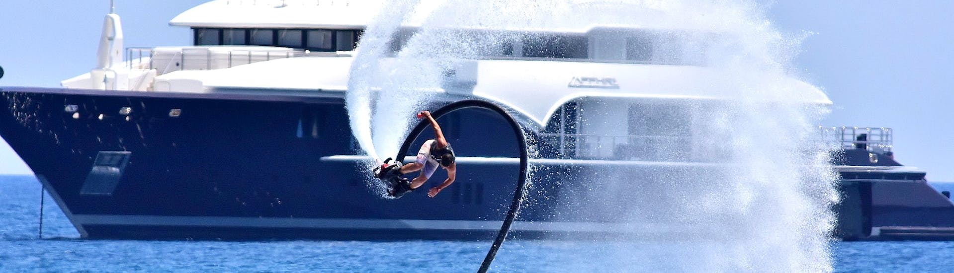 Man does a stunt on the flyboard rented from St. Nicholas Beach Watersports Zakynthos.