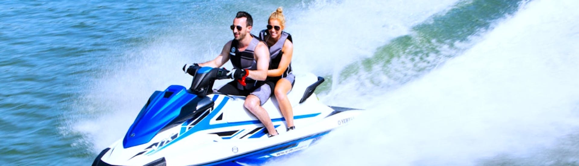 Two participants on a jet ski, driving around the Bay of Estepona, while doing a jet ski tour with South Olé Sails Estepona.