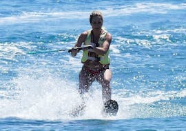 Woman stands on a water ski rented from St. Nicholas Beach Watersports.