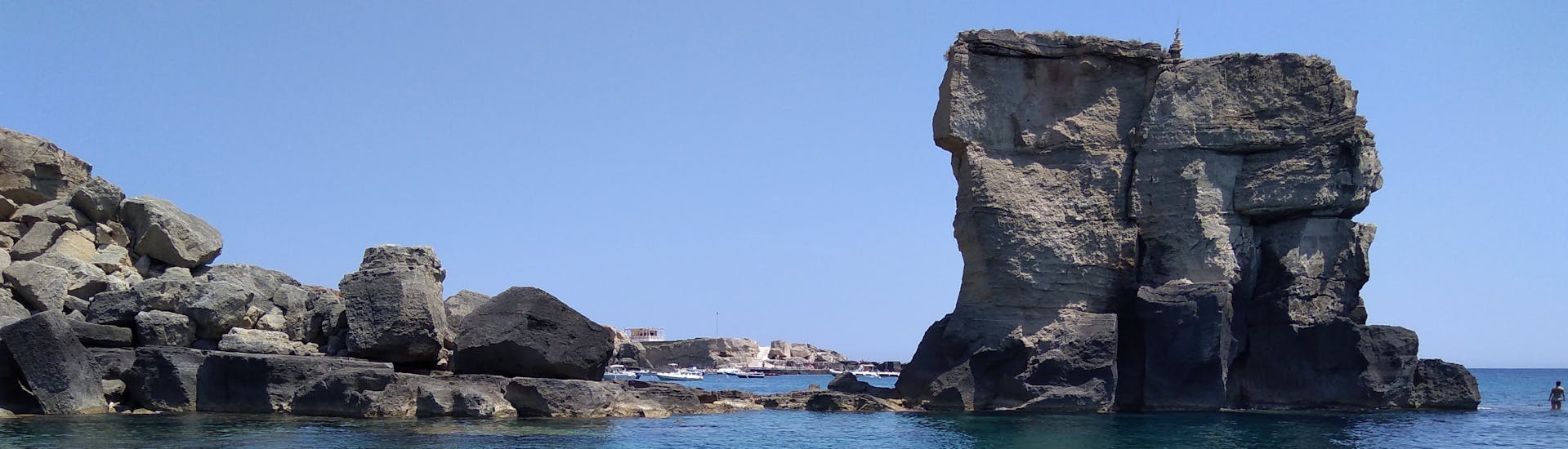 View of the sea stack of porto Miggiano during the Private Boat Trip to the Castro Caves with Nautica Red Coral Salento.