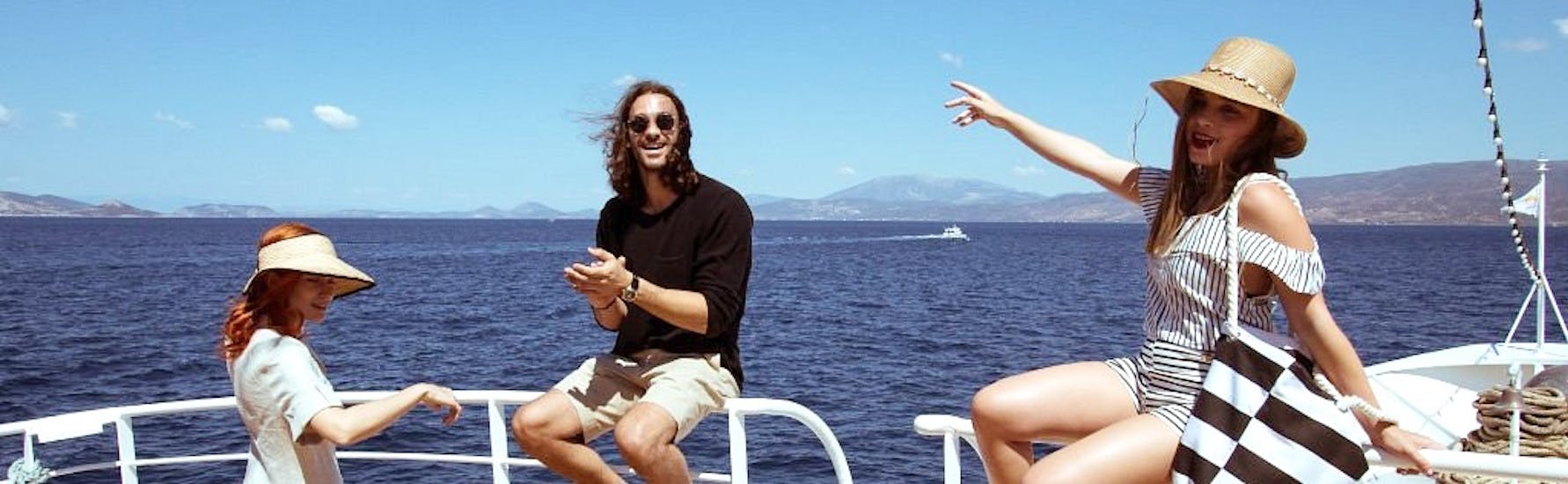 Guests pose happily on the deck of the Athens Day Cruise boat.