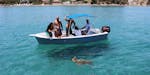 Eine Gruppe an Freunden fotografieren eine Schildkröte auf der Bootstour mit Schildkrötenbeobachtung ab Agios Sostis.