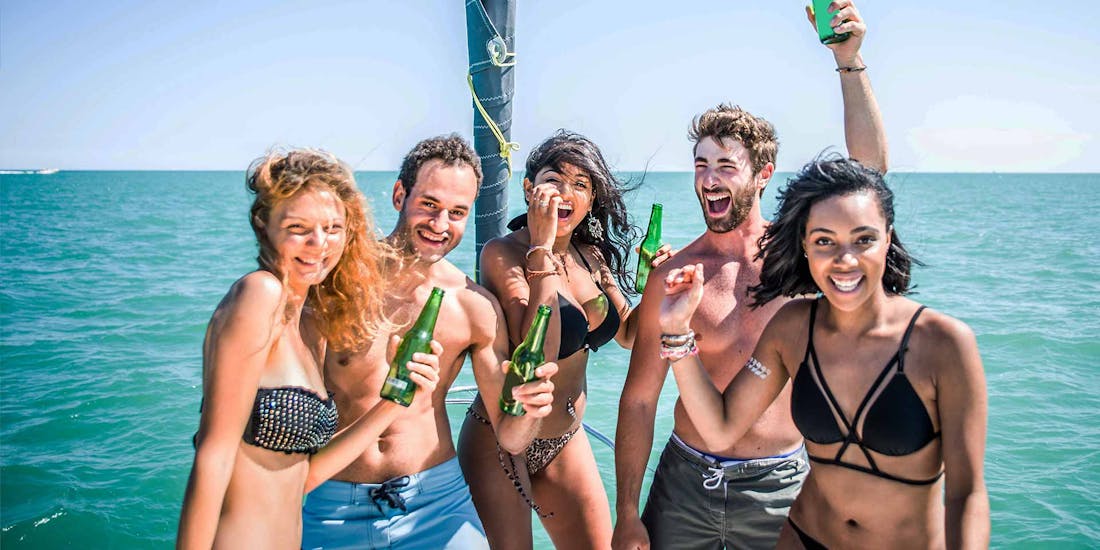 A group of participants drinking and having fun on a party boat in Mykonos during an activity with Mykonos Boat Club.