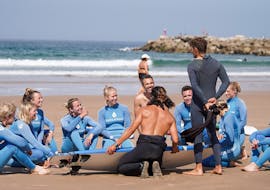 A group of people smiling after their lesson in Praia do Tarquínio with Gota Dagua Surf School.