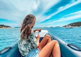 A woman sitting in the boat during the Private Boat Trip along the Coast of Šibenik with Anima Natura Šibenik.
