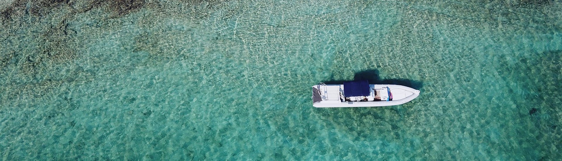 The RIB boat from SEAze the Day floating on the crystal clear waters of Crete.
