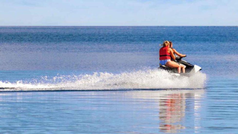 2 friends ride a jet ski over the blue water at the jet ski hire in Umag with Levante Watersports Umag.