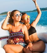 Two friends sit on the luxury boat and enjoy the view on the private boat trip from Umag with Levante Watersports Umag.