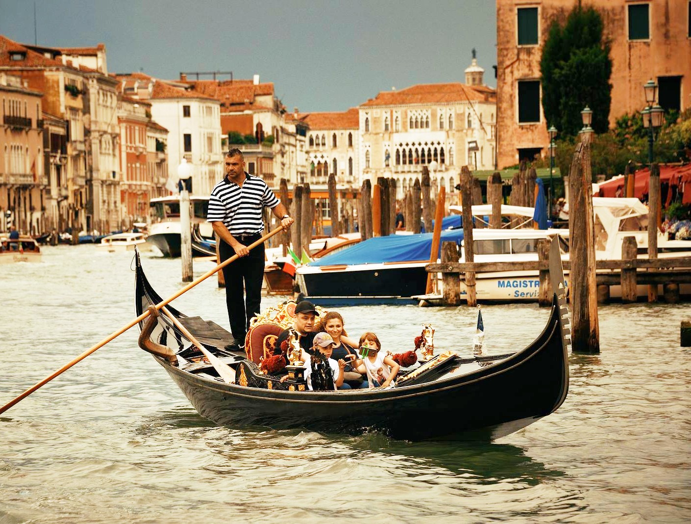One of our gondolas as it sails through the canals of Venice during a gondola ride with aperitivo in Venice at sunset with Park View Viaggi.