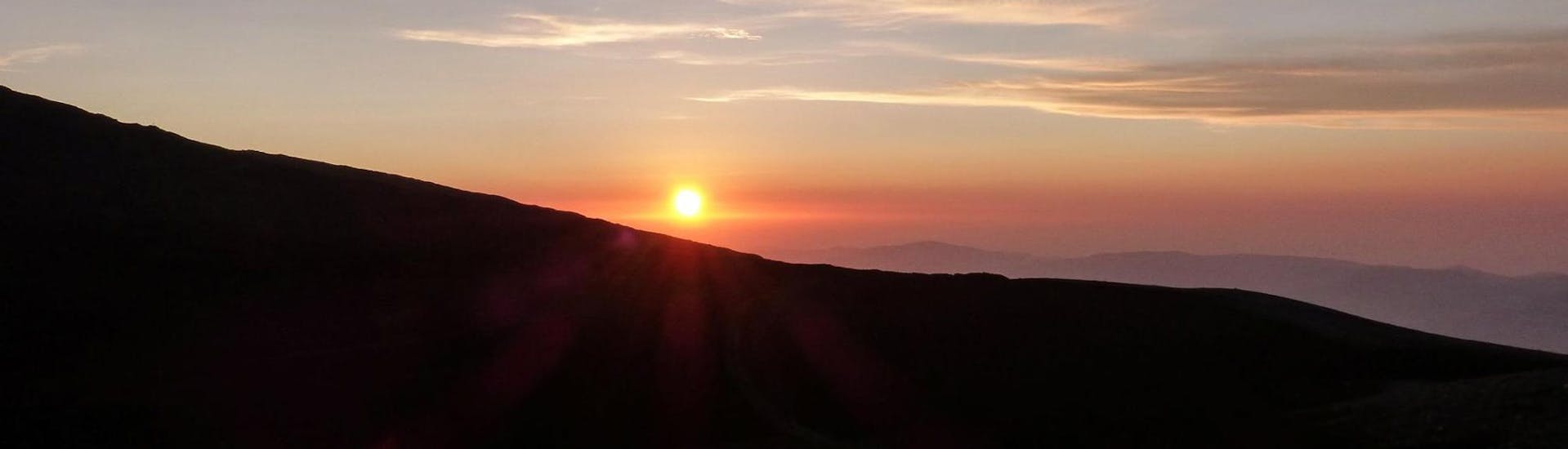 The sun sets behind a slope during the Sunset Excursion to Mount Etna from Taormina with SAT excursions Taormina.