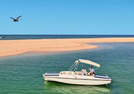 A boat on the beautiful blue water during the Boat Trip along Ria Formosa with Birdwatching from Lands - Eco Boat Tours.