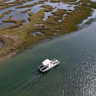 A boat on the beautiful Marshes of Ria Formosa during the Boat Trip from Faro along the Marshes of Ria Formosa from Lands - Eco Boat Tours.