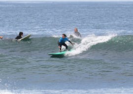 A group of people enjoying their surf lesson in Ericeira on Praia do Matadouro with Boardculture Surf Center.