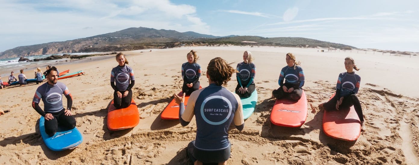 A group of people at the beach during Surf Lessons on Carcavelos or Guincho Beach in Cascais with Surf Cascais.