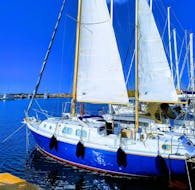 Our beautiful sailboat at the harbor before a private sailing trip from Alghero to Porto Conte Park with lunch with Coral Sail Alghero.