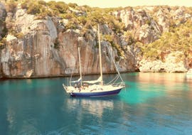 Onze zeilboot terwijl hij de wateren van de Middellandse Zee bevaart tijdens een privé zeiltocht vanuit Alghero met een aperitief bij zonsondergang met Coral Sail Alghero.