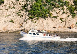 The boat of HP Travel Capri navigating along the coast during the Boat Trip from Sorrento to Capri with Swimming & Limoncello Tasting.