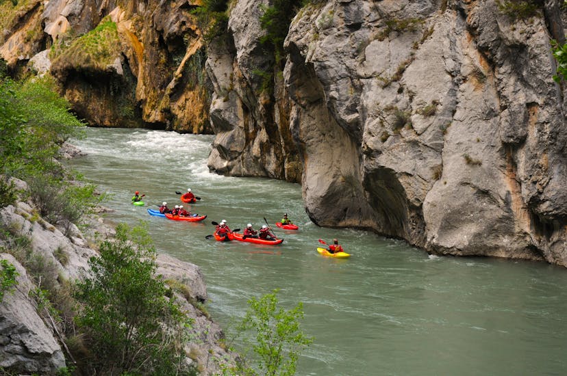 A participant having fun on an adrenaline-packed kayaking activity on the Noguera Pallaresa during kayaking from Arboló to Figuereta with La Rafting Company Sort.