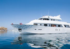 The Ocean Flyer anchored during a Luxury Yacht Trip to Coral Bay & the Sea Caves - Adults Only with Paphos Sea Cruises.