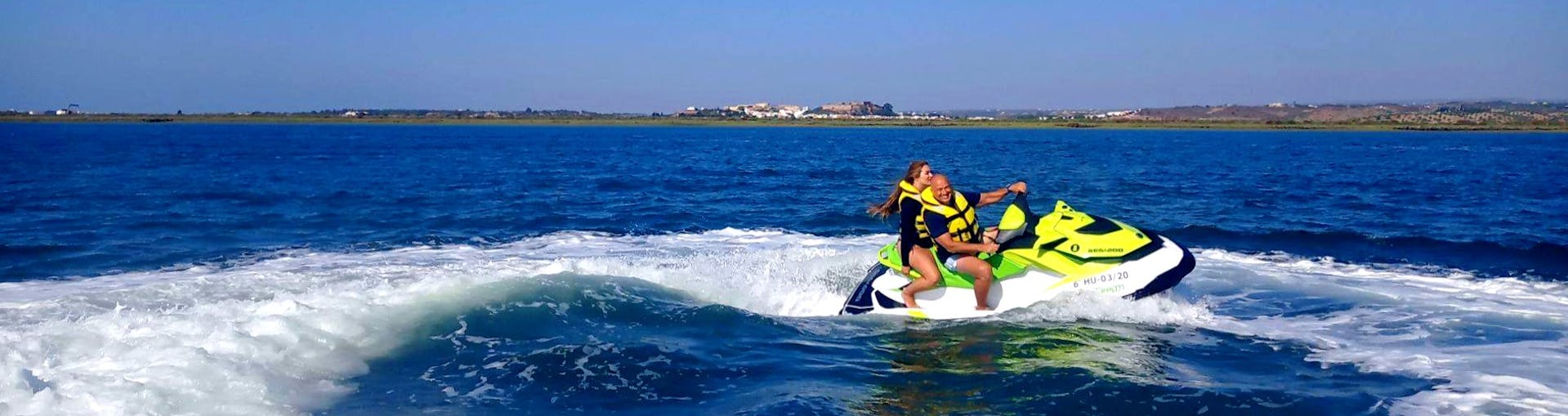 Two participants splashing around in the waters of the Guadiana River, having fun during a jet ski safari with Jet Ski Dreams Huelva.