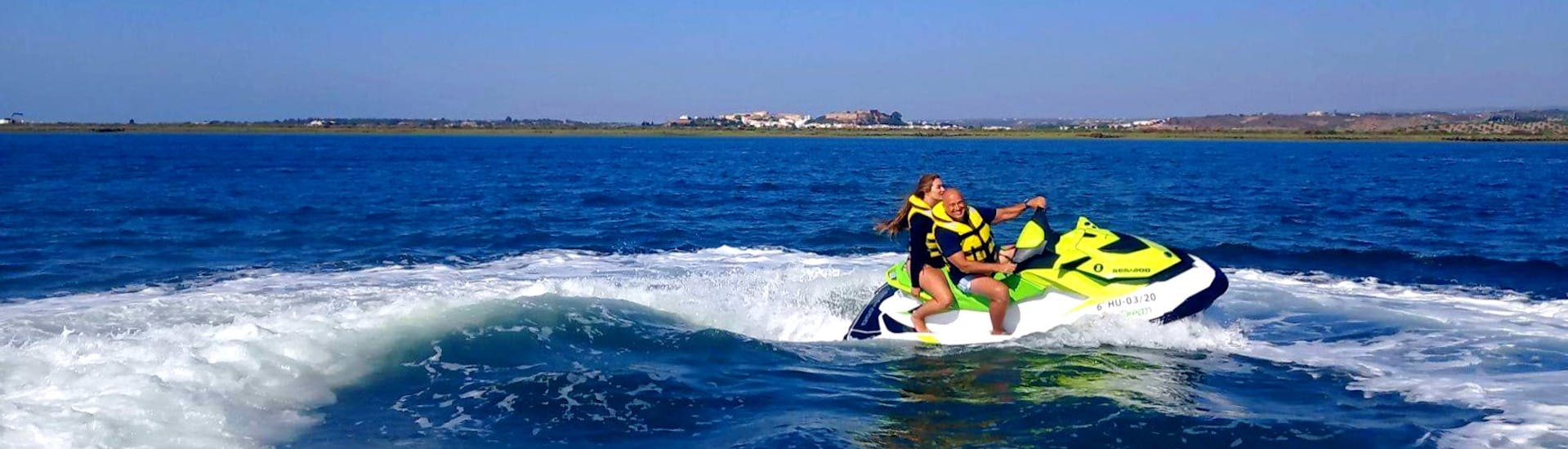 Two participants splashing around in the waters of the Guadiana River, having fun during a jet ski safari with Jet Ski Dreams Huelva.