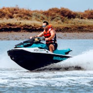 A participant having fun while jet skiing towards the bridge uniting Portugal and Spain along the River Guadiana with Jet Ski Dreams Huelva.