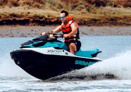 A participant having fun while jet skiing towards the bridge uniting Portugal and Spain along the River Guadiana with Jet Ski Dreams Huelva.