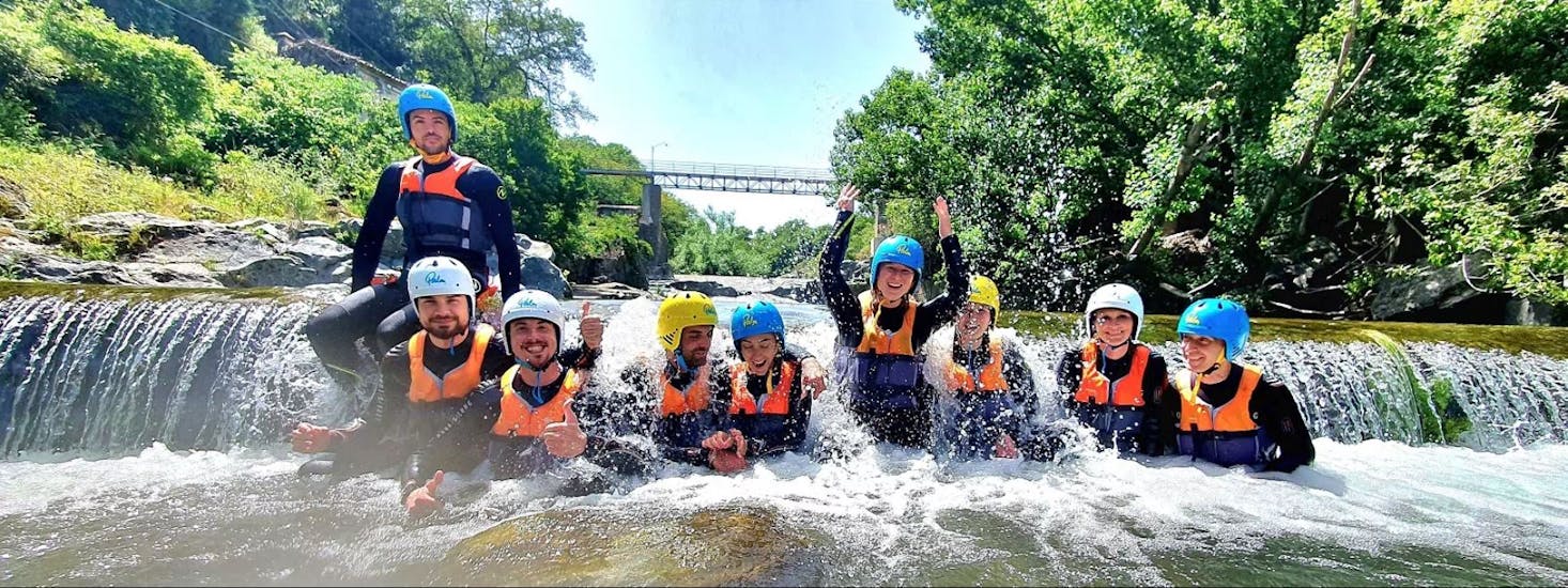 A group of people smiling in the river doing Body Rafting in the Gole dell'Alcantara with Sicily Adventure Taormina.