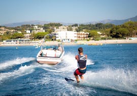 A man is being towed by a boat while Waterskiing in Cagnes-sur-Mer with Cagnes Watersports.