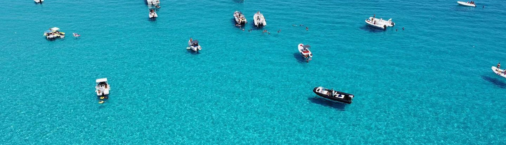 Boats are mooring in the crystal clear water off the coast during one the Private Boat Trip from Castellamare to Riserva dello Zingaro.
