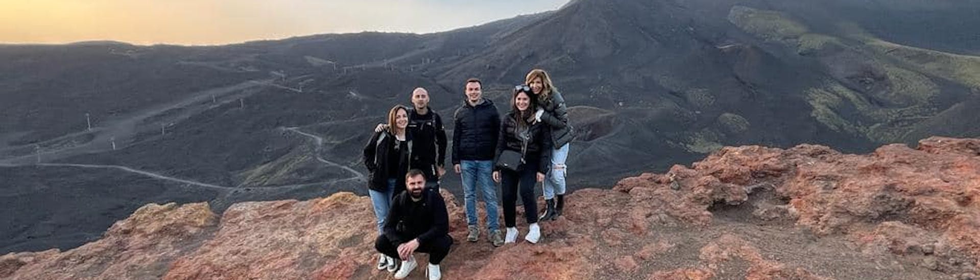 A group of friends smiling on Etna during the Sunset Jeep Tour on Etna with Tasting of Sicilian Products with Etna & Sea Excursions Catania.