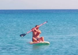 A man does a SUP Hire on Kefalos Beach with Water Club Poseidon Kos.