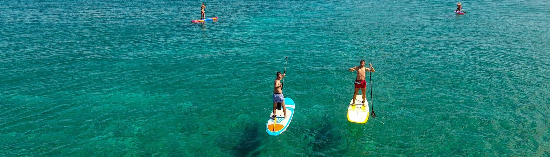 Two guys on an SUP from the SUP Hire at Paradise Beach in Kos with Water Club Paradise Beach Kos.