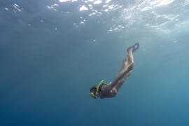 Picture of a person snorkeling in the sea during the Sunset Boat Trip to Macari with Snorkeling with San Vito Sea & Sub Service.