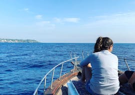 A girl sitting in the boat of Etna & Sea Excursions Catania during the Jeep Tour on Etna and Boat Trip along the Coast.