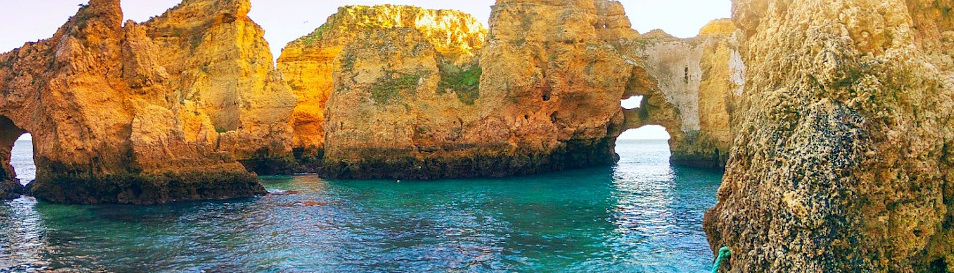 The stunning Ponta da Piedade gleaming with the sunlight of a beautiful day during a boat trip with swimming with Funtastik Tours Lagos.