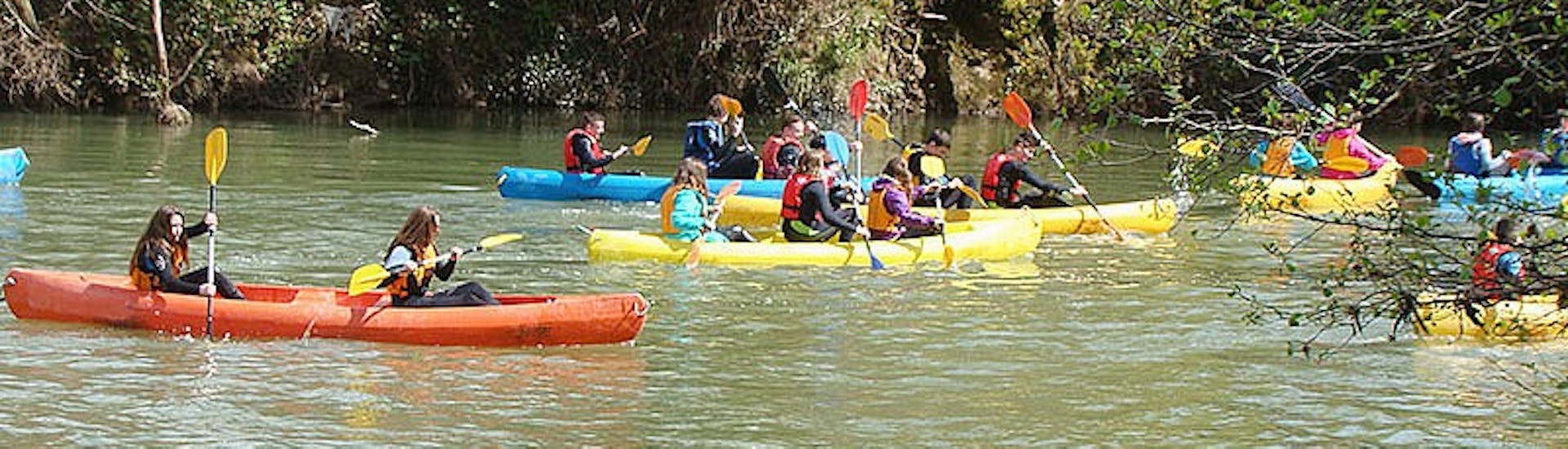 People enjoying while Canoeing on the Deva River from Pesues with Cantabria Activa.