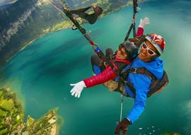 A woman and her pilot enjoying the flight while Tandem Paragliding from Beatenberg in Interlaken with AlpinAir Paragliding Interlaken.
