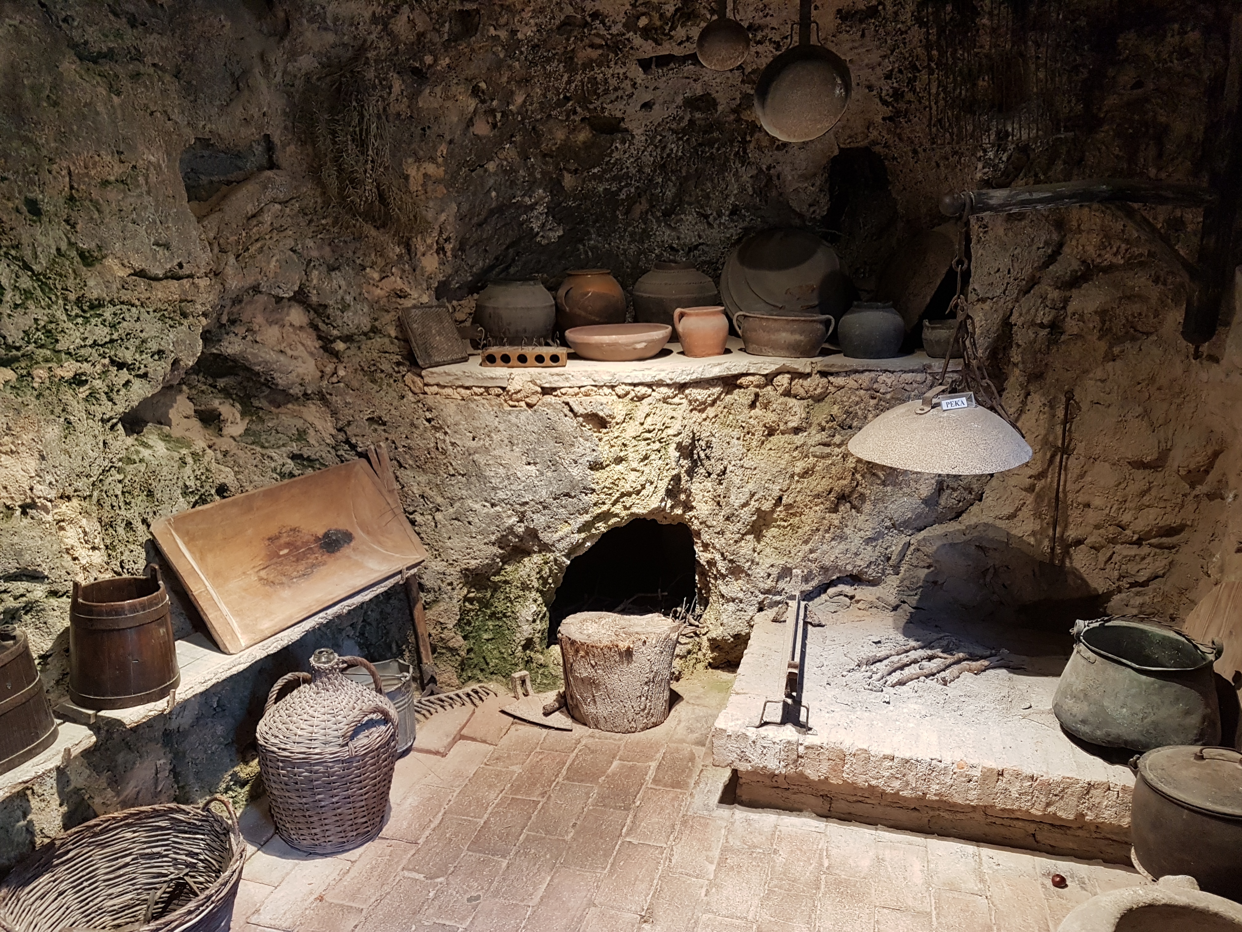 Traditional blacksmith's workshop and kitchen in Krka National Park A traditional stone kitchen with clay pots and a hearth is displayed at an ethno-village during the Avalon Yachting Šibenik boat trip to Krka National Park from Šibenik with lunch and drink.