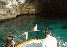 A couple navigating during a Private Boat Trip from Ċirkewwa to Malta's Best Places with Outdoor Explorers.