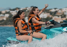 Two friends riding a jet ski during a Jet Ski in Andratx in Mallorca with GoJet Jet Ski.