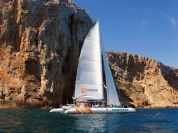 An elegant eco sailing catamaran with participants having fun during a sailing boat trip along the Bay of Malaga with Mundo Marino Costa del Sol.