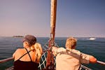Two people doing a Sunset sailing Trip from Poreč with Dolphin Watching with Santa Maria Boat Cruises Poreč.