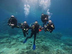 Picture of 5 divers swimming through the underwater landscape with Cyprus Diving Adventures.