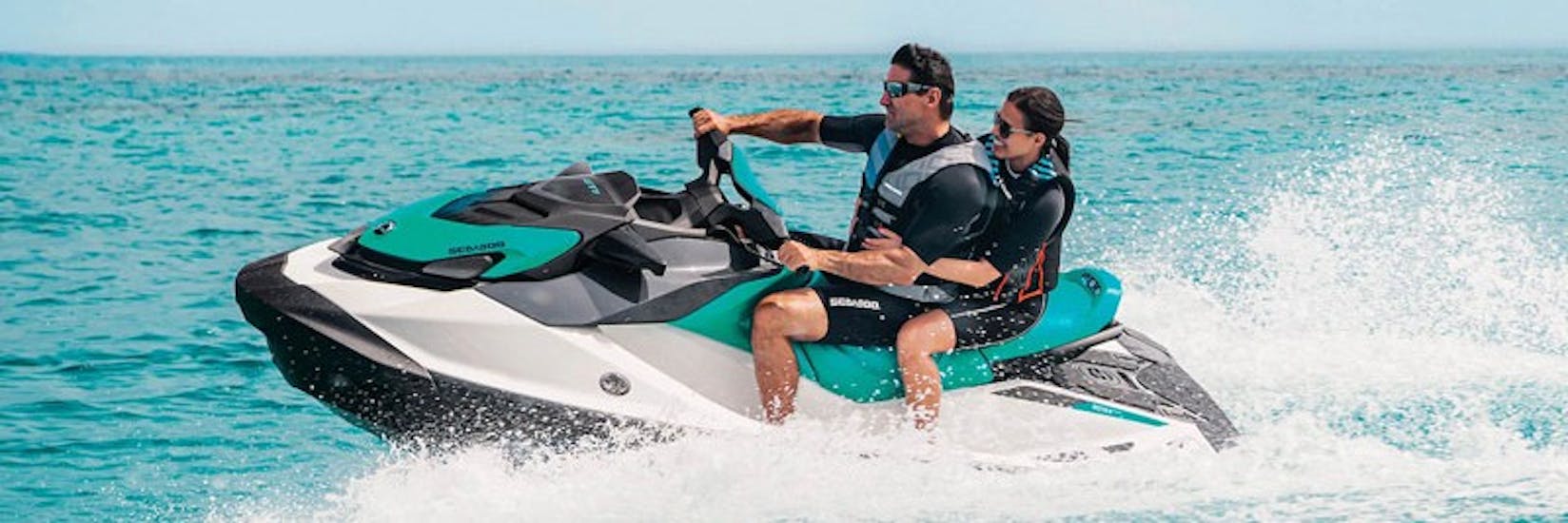 A couple cruising over the sea during the Jet Ski Hire in Krk with Rent a Boat & Jet Ski Krk.