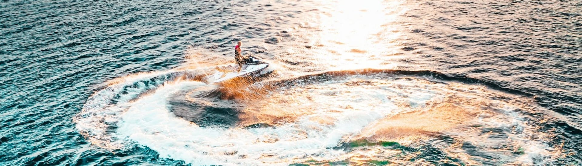 Ein Jetski von Lux Rent A Boat & Jet Ski Vrsar auf dem Wasser während des Sonnenuntergangs.