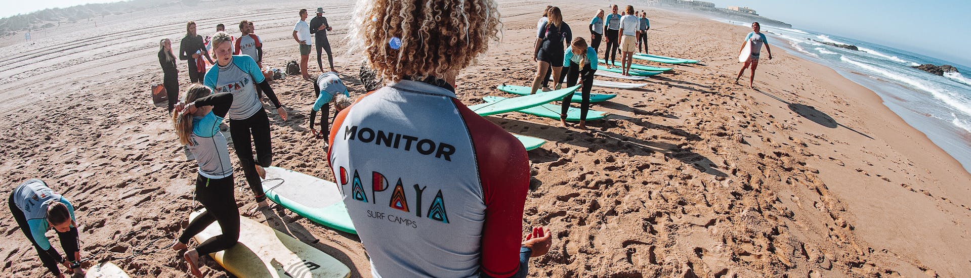 The instructor is monitoring the students during the Private Surf Lessons in Cascais near Lisbon with Papaya Surf Camp.