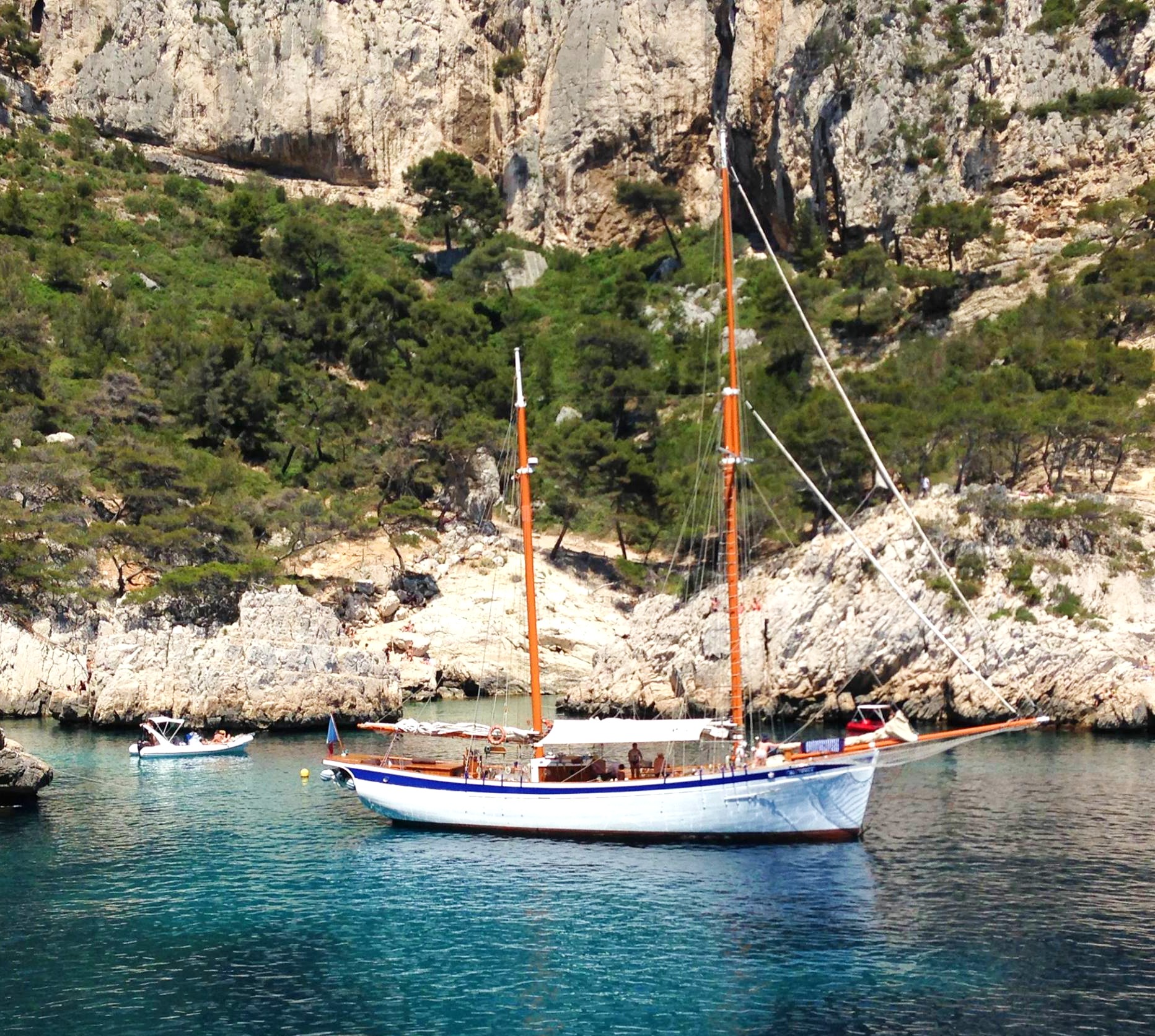 Our boat La Goélette Alliance anchored in a creek during the Sailing Trip to the Calanques of Marseille with Snorkeling.