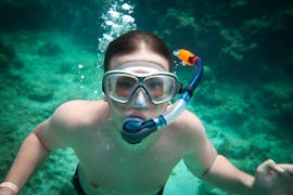 A participant dives underwater on a snorkelling trip by boat to Pserimos Island from Kos with Liamis Dive Center.